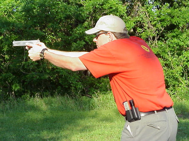 Bill Bradford aiming a handgun